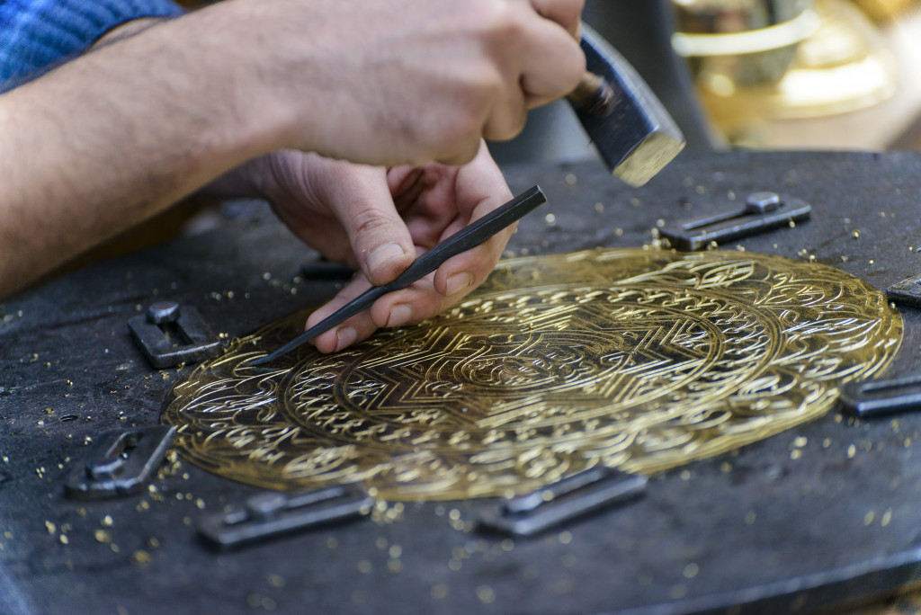 Two Hands of Craftsman Engraving Brass Plate Masterpiece