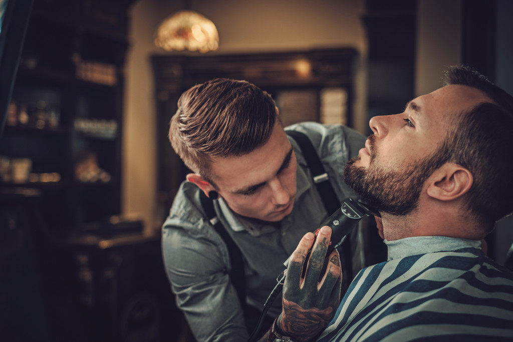 barber giving a shave to a customer