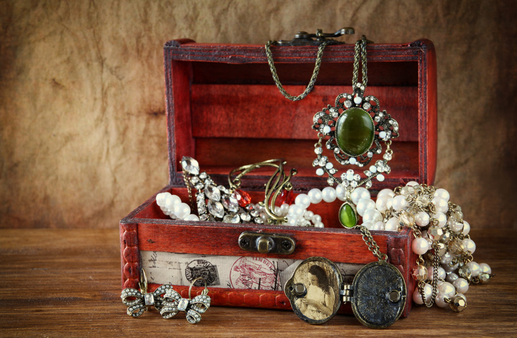 Box filled with vintage jewelry and trinkets